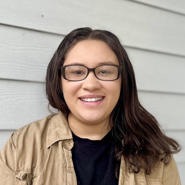 Jayden Graves, Memory Care Director at Vitalia Solon, smiling in front of a light gray siding background.